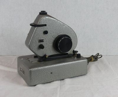 an old camera that is sitting on a white surface
