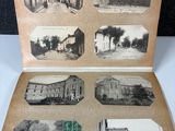 an old photo of a book opened to show pictures of buildings