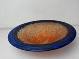 a blue and orange bowl sitting on a white surface