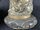 a bronze statue of a bear on a base