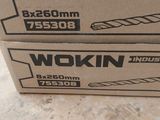 two boxes of wokin tools are sitting on the floor