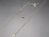 two gold necklaces and a pair of earrings on a table