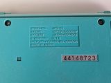 a close up of a blue electronic device on a table