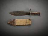 an old knife and a small knife on a gray surface