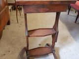 a wooden table with a shelf on it in a room