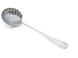 silver spoon with a flower design on it on a white surface