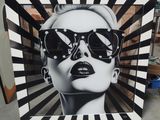 black and white photograph of a woman wearing sunglasses with a black and white background