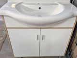 a white sink and a cabinet in a room