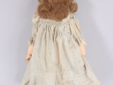a close up of a doll wearing a dress and shoes