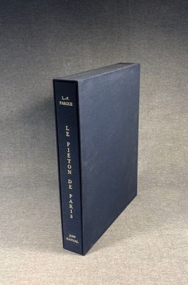 a black book sitting on top of a table next to a gray wall