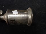 a small metal object with a tag on it