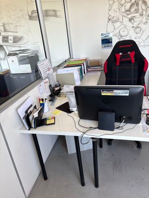 a desk with a chair and a computer on it