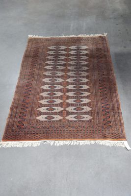 a brown and black rug with a diamond design on it