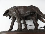 a statue of a dog pulling a man on a sled
