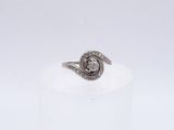 a close up of a diamond ring on a white pedestal