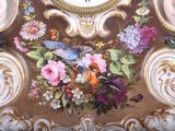 a clock that is decorated with flowers and birds on it