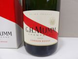 a bottle of wine sitting next to a box of cigarettes