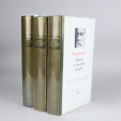 three books sitting on top of each other on a white surface