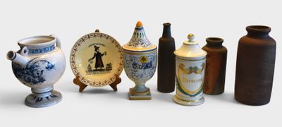 many vases and plates that are lined up on the table