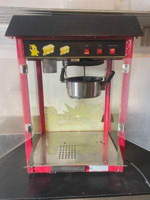 a popcorn machine that is sitting on a counter