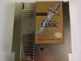 a metal comb with a sword on it on a white surface