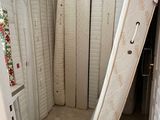many mattresses stacked up in the corner of a room