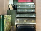 many books in a box that are stacked up