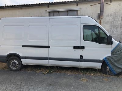 a white van that is parked in front of a building