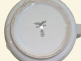a close up of a white bowl with an eagle on it