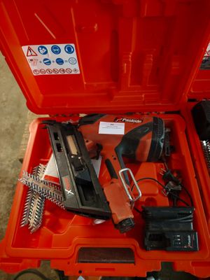 a red tool box with tools in it on the floor