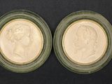 two small glass plates with two heads of a man and a woman