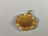 an image of a gold locke with a flower design on it