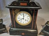 a clock that is sitting on a table next to other items