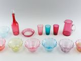 many different colored glasses and a toothbrush in a row