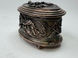 a silver box with a lid on a white surface
