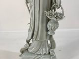 a statue of a woman holding a basket of flowers