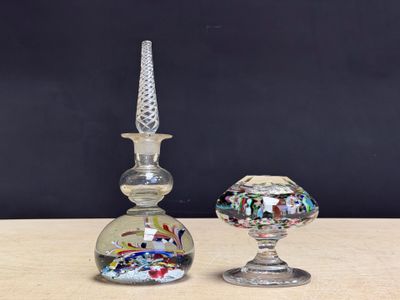 pair of glass candlesticks and a glass candle holder on a wooden table