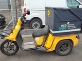 a yellow scooter that is parked on the side of the street
