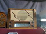 two old radio ' s sitting on a red table