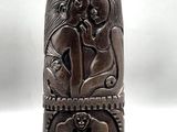 an image of a wooden sculpture of a couple on a bench