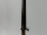a close up of a knife hanging on a wall on a wall