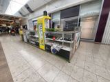 a vending machine in the middle of the floor in a mall