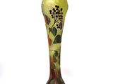 a glass vase with a painting on it sitting on a table