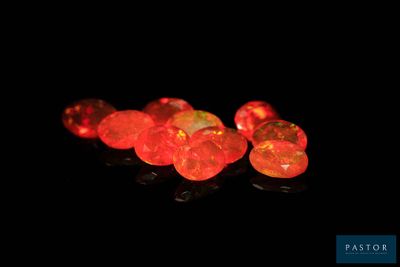 several red fire oplite stones are lit up in the dark