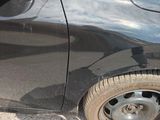 a black car that is parked on the side of the road