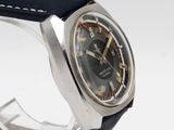 a watch that is sitting on a stand on a white surface