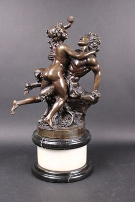 a bronze statue of a man and a woman on a pedestal