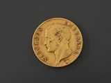 a close up of a gold coin on a black surface