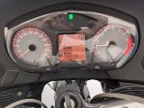 a close up of a motorcycle with a speedometer and gauges
