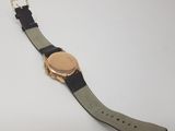 the watch is laying on the table with a black strap